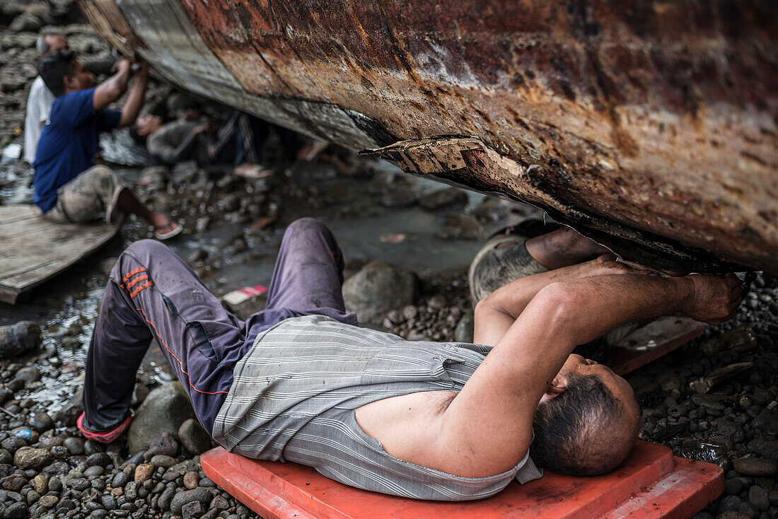 Repairing old fishing boats near Iboih, Pulau Weh Island, Aceh Province, Sumatra, Indonesia