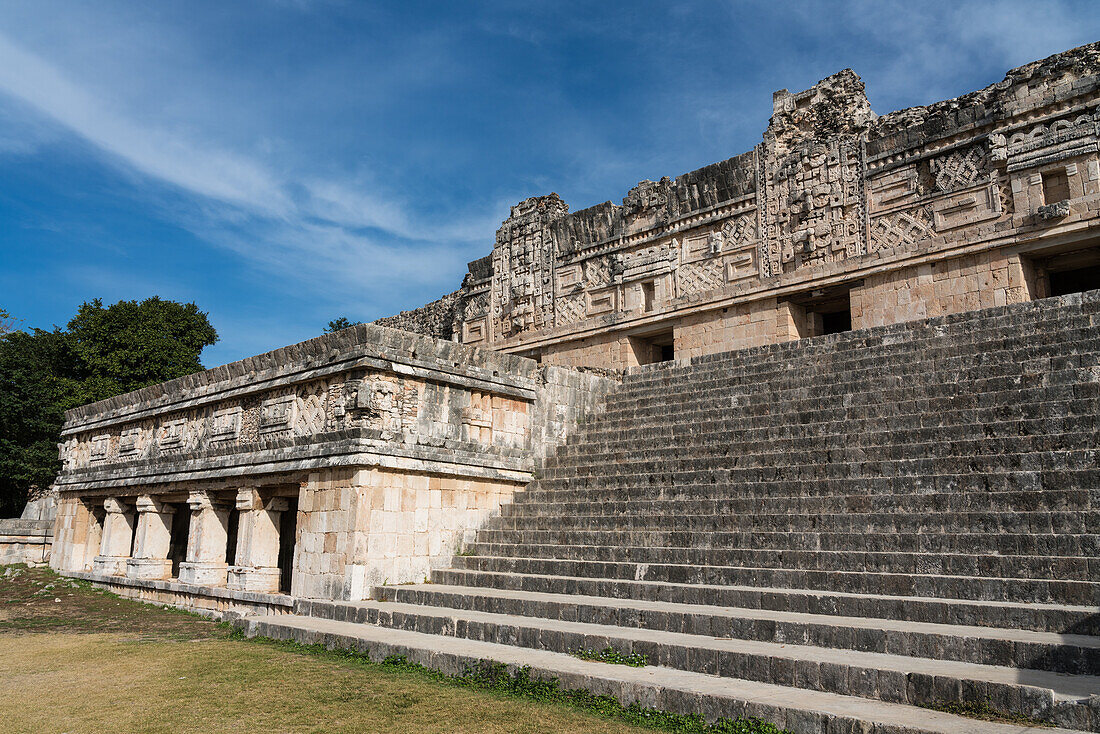 The north building of the Nunnery Quadrangle in the pre-Hispanic Mayan ruins of Uxmal, Mexico, with one of its associated temples in front.