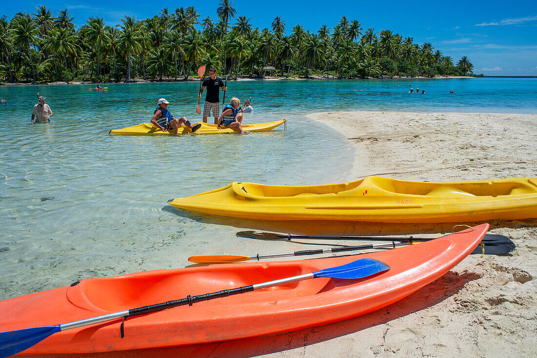 Kayaking in Taha'a island beach, French Polynesia. Motu Mahana palm trees at the beach, Taha'a, Society Islands, French Polynesia, South Pacific.