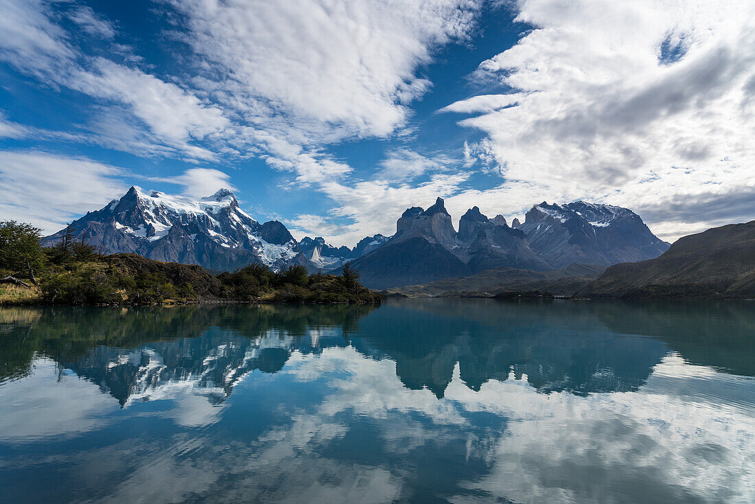 Early morning reflections of the Paine Massif in Lago Pehoe in Torres del Paine National Park, a UNESCO World Biosphere Reserve in Chile in the Patagonia region of South America.