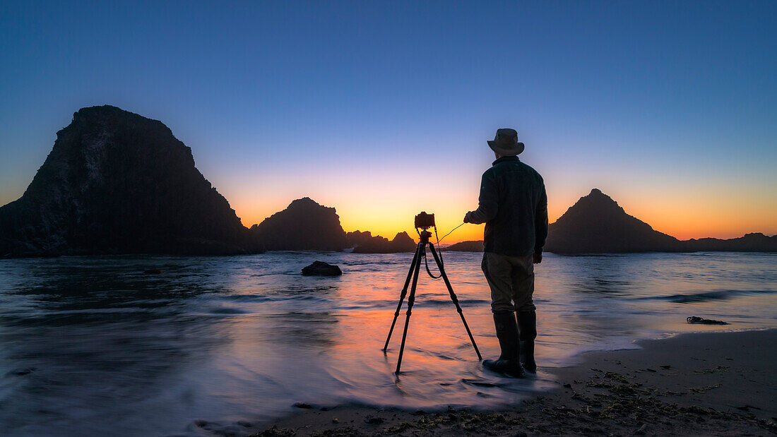 Alex Morley photographing sea stacks at sunset at Seal Rock State Park, central Oregon Coast.