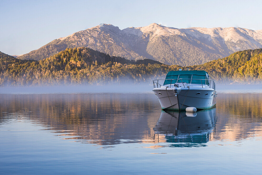 Sped boat on a misty Lake Nahuel Huapi at sunrise, Villa la Angostura, Neuquen, Patagonia, Argentina