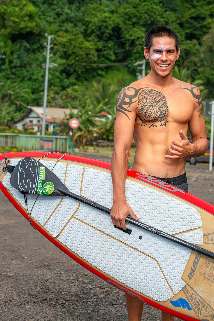 Surfer at Beach with black sand on Pointe Venus, Tahiti, French Polynesia, Tahiti Nui, Society Islands, French Polynesia, South Pacific.