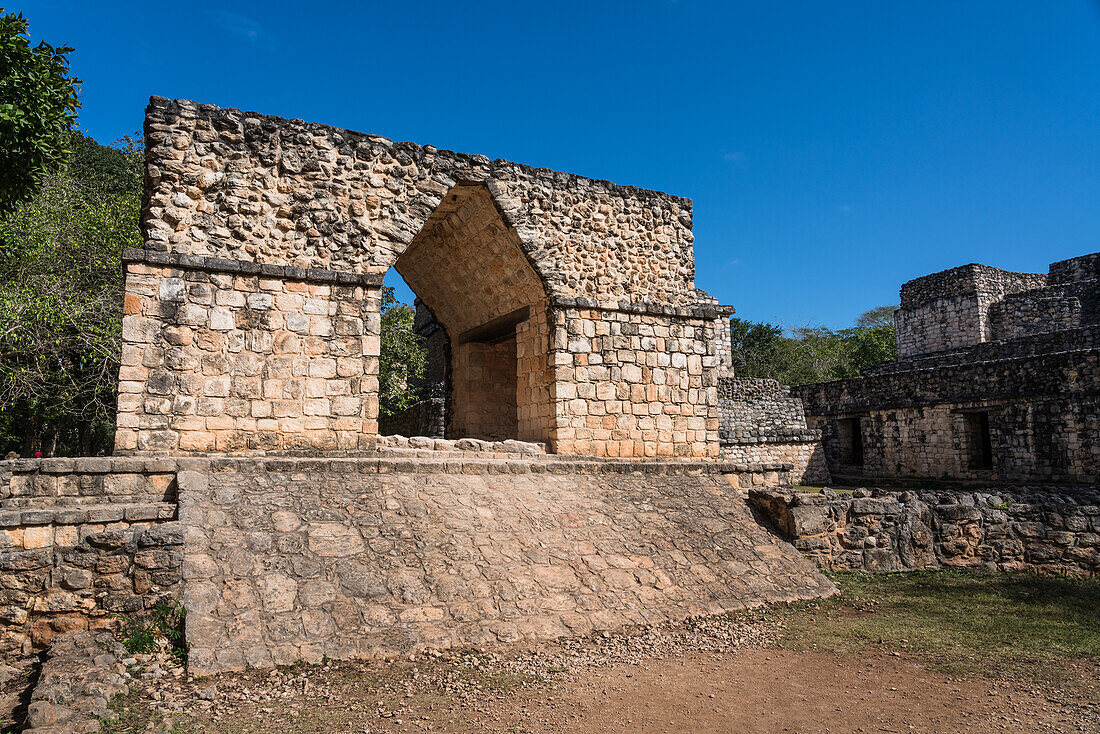 The Entrance Arch in the ruins of the pre-Hispanic Mayan city of Ek Balam in Yucatan, Mexico. Behind the arch is Structure 17 or the Twins, with the Oval Palace to the right.