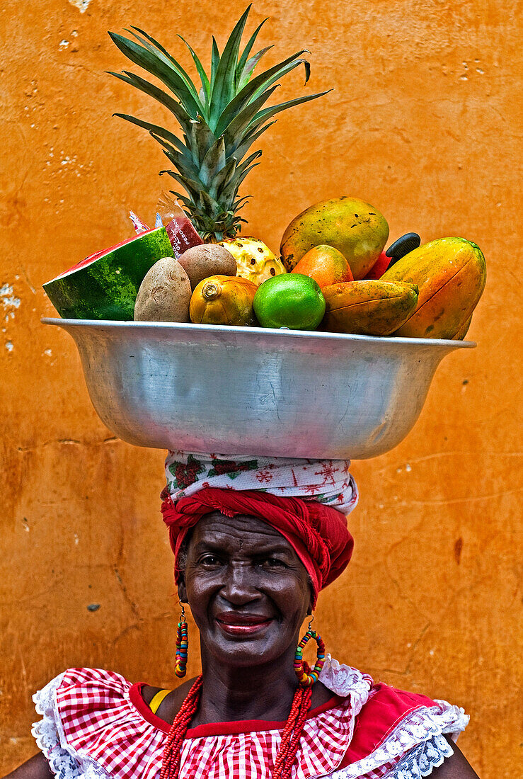 Eine Palenquera-Frau verkauft Früchte in Cartagena, Kolumbien. Die Palenqueras sind eine einzigartige afrikanischstämmige ethnische Gruppe im Norden Südamerikas.