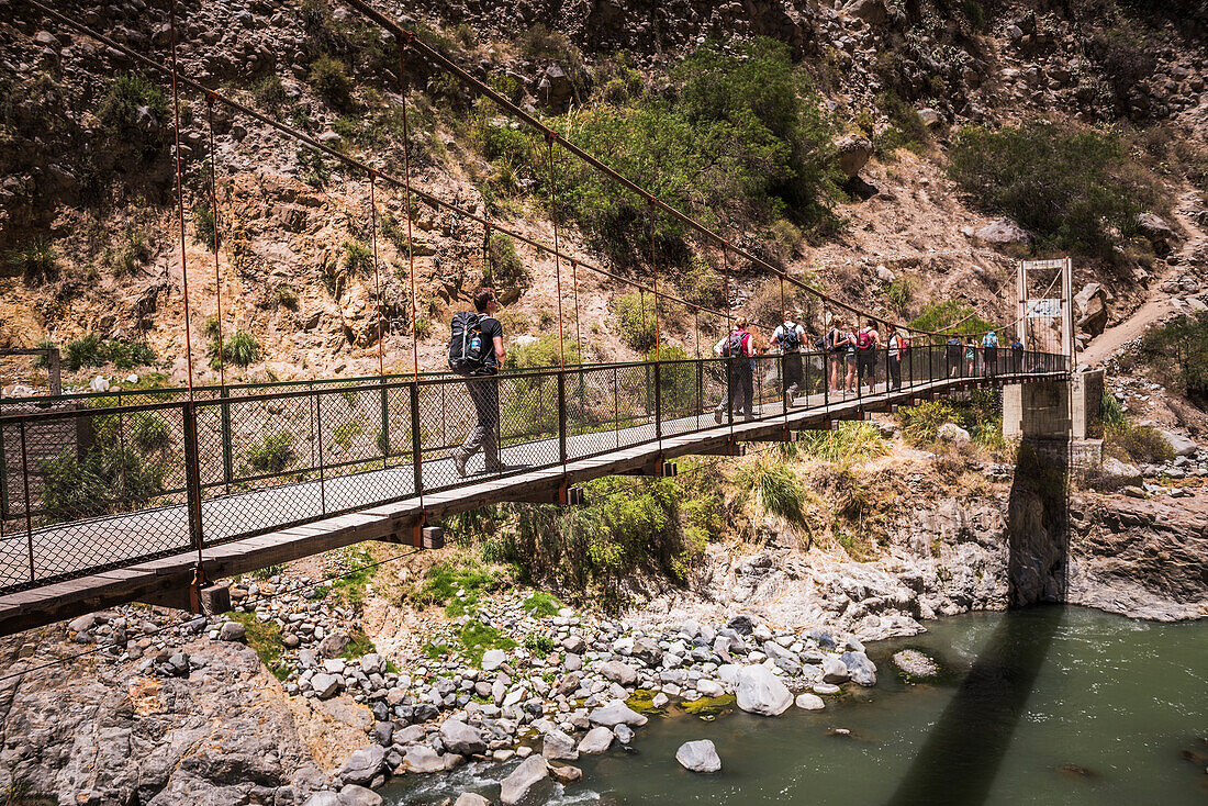 People trekking over Colca River Bridge, Colca Canyon, Peru