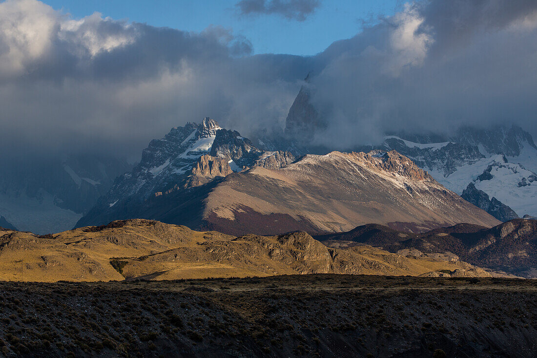 Clouds obscure the Fitz Roy Massif in Los Glaciares National Park near El Chalten, Argentina. A UNESCO World Heritage Site in the Patagonia region of South America. Visible are Loma de las Pizarras and Techado Negro, with half of Cerro Poincenot behind.