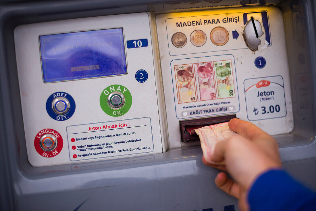 Using the tram ticket machines, Istanbul, Turkey