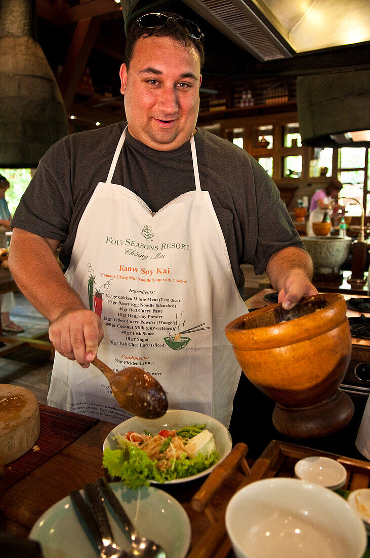 Learning to cook Thai food at the Four Seasons Resort cooking class in Chiang Mai, Thailand.