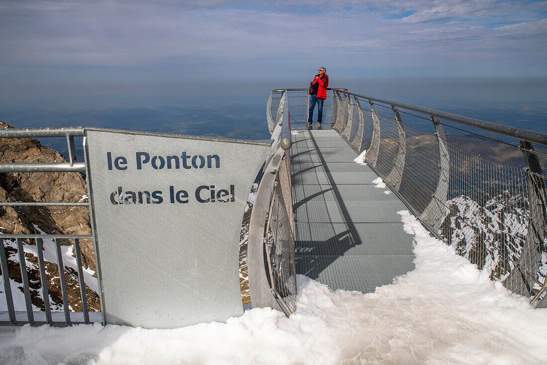 View point of The Observatory Of Pic Du Midi De Bigorre, Hautes Pyrenees, Midi Pyrenees, France. The 12m Ponton dans le ciel, a glass walkway high above the Pyrenees at Pic du Midi de Bigorre, a 2877m mountain in the French Pyrenees, home to an astronomical observatory and visitors centre. The observatory is acccessible from the village of La Mongie by cablecar. Tourists often visit in time for the spectacular sunset across the mountains.