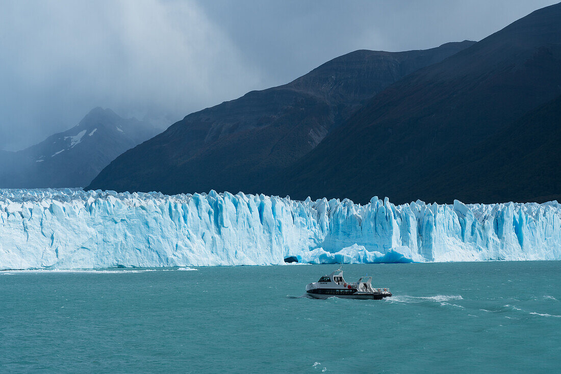 A tour boat on Lago Argentino takes tourists for a close-up view of the Perito Moreno Glacier in Los Glaciares National Park near El Calafate, Argentina. A UNESCO World Heritage Site in the Patagonia region of South America.