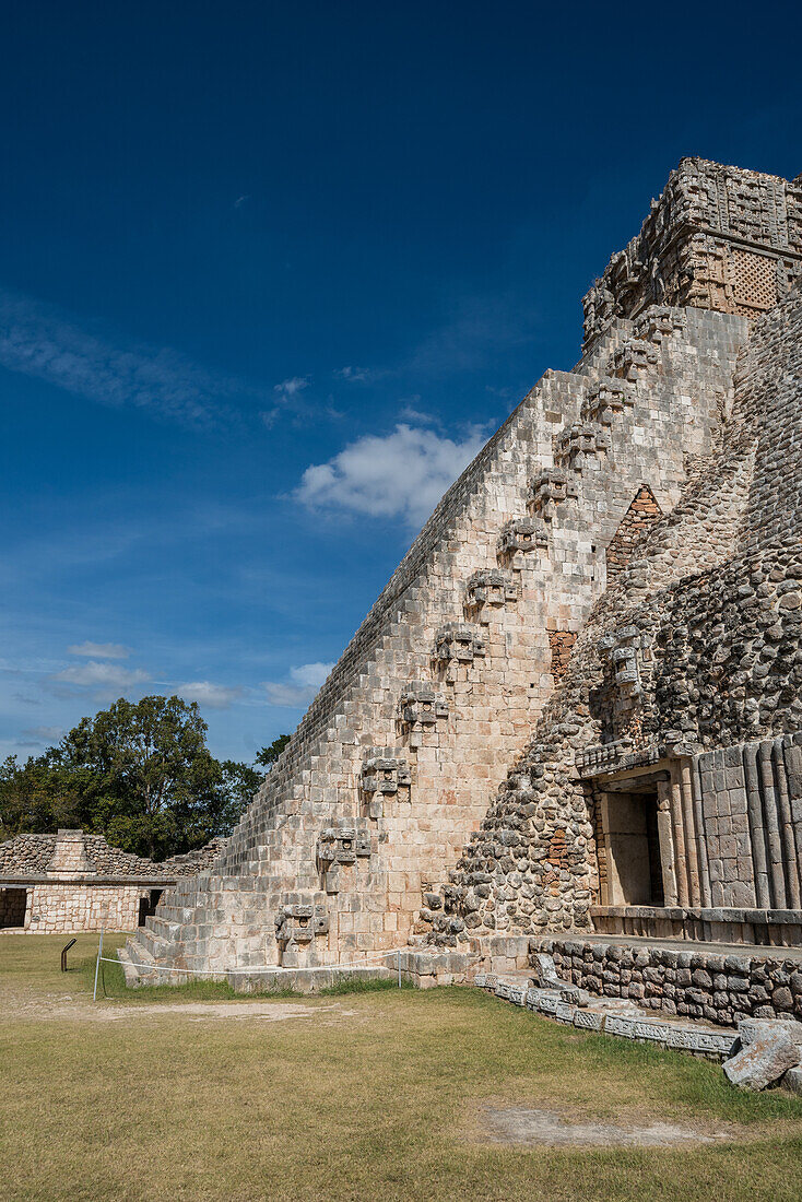 Die Westseite der Pyramide des Magiers liegt gegenüber dem Viereck der Vögel in den Ruinen der Maya-Stadt Uxmal in Yucatan, Mexiko. Die prähispanische Stadt Uxmal - ein UNESCO-Weltkulturerbe.