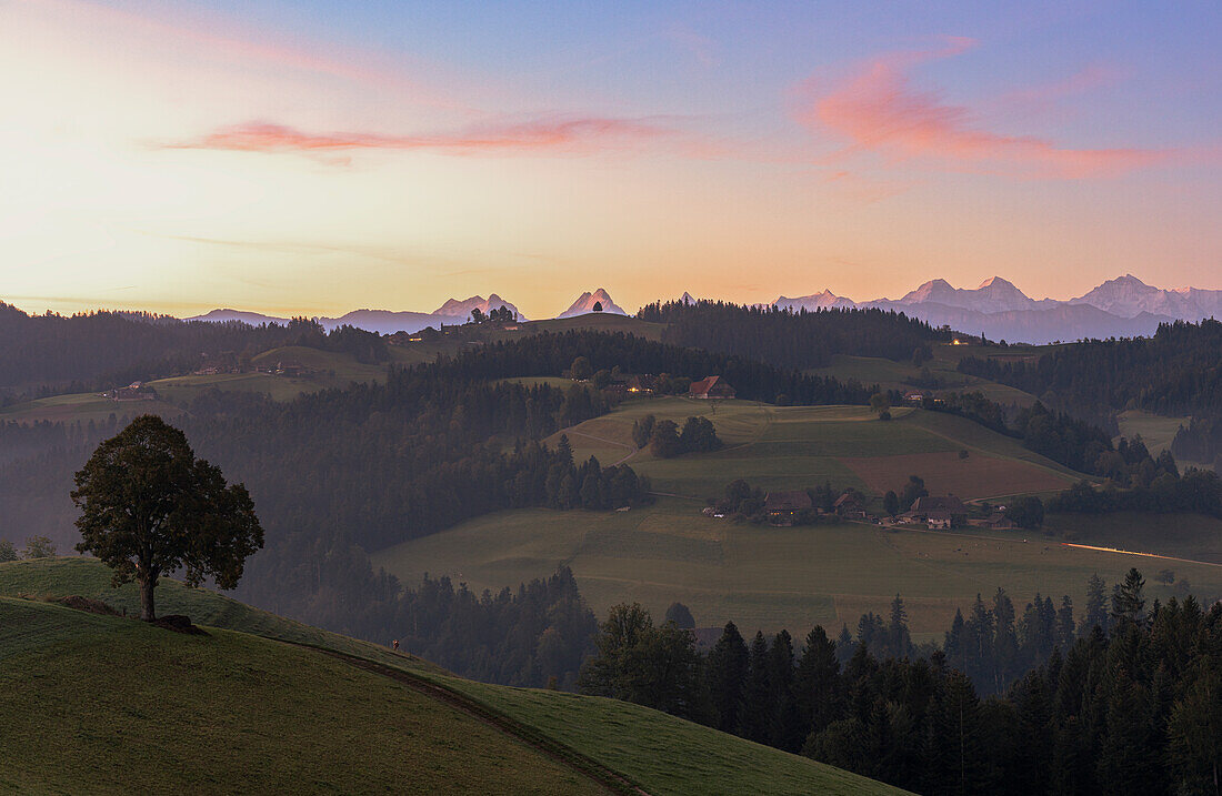 Green rolling hills and forest in the autumn mist at dawn, Sumiswald, Emmental, canton of Bern, Switzerland, Europe