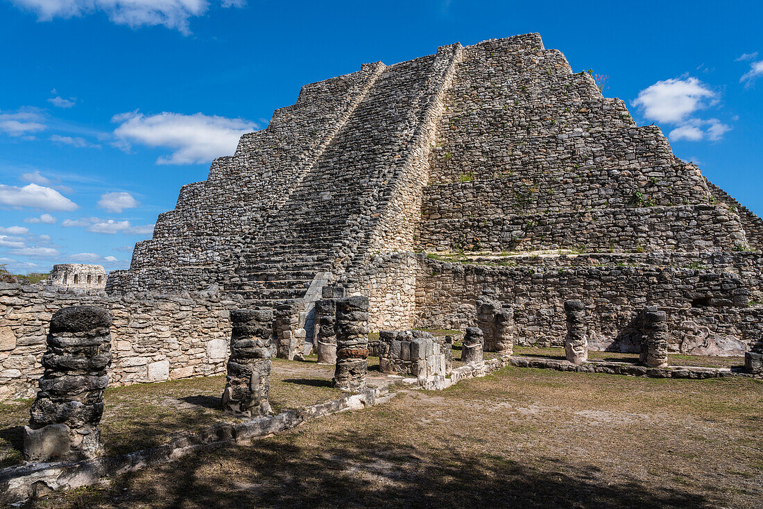 The remaining colonnades of the Room of the Kings in front of the Pyramid of Kukulkan or Castillo in the ruins of the Post-Classic Mayan city of Mayapan, Yucatan, Mexico.