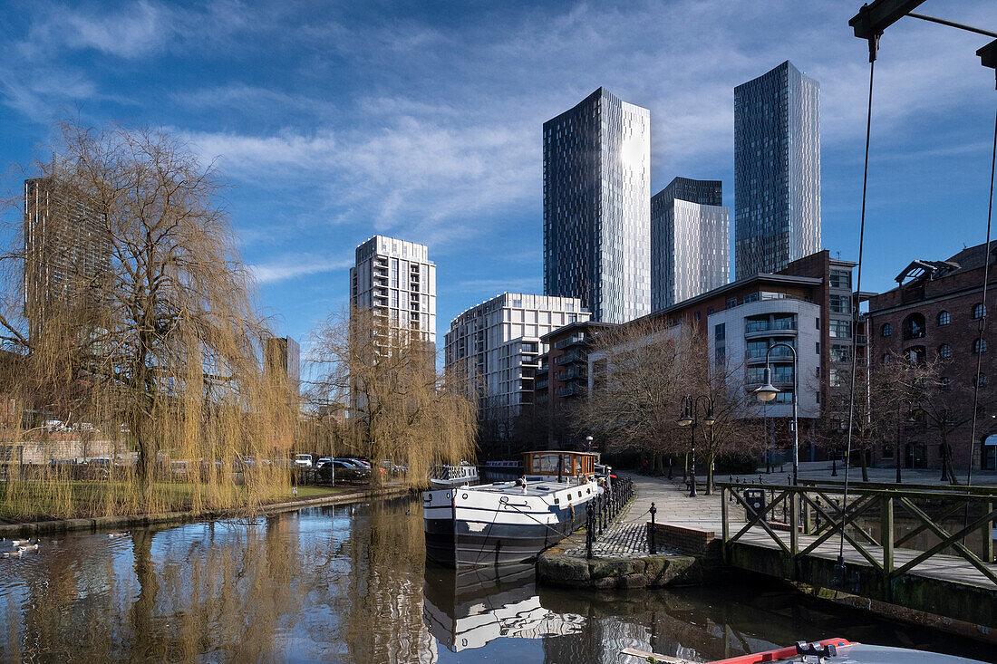 The Bridgewater Canal and Castlefield Basin backed by Manchester skyscrapers, Castlefield, Manchester, England, United Kingdom, Europe