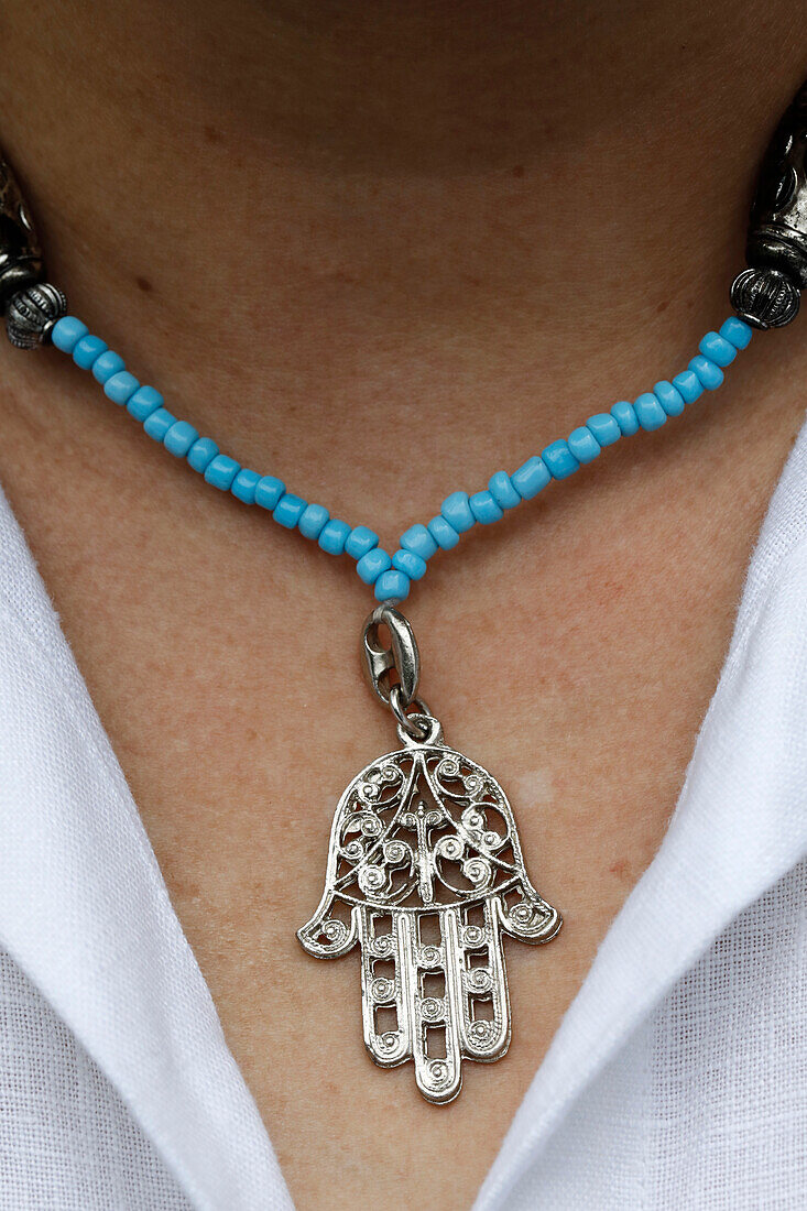 Woman wearing a Muslim hamsa amulet (the Hand of Fatima) (the Hand of Mary), Vietnam, Indochina, Southeast Asia, Asia