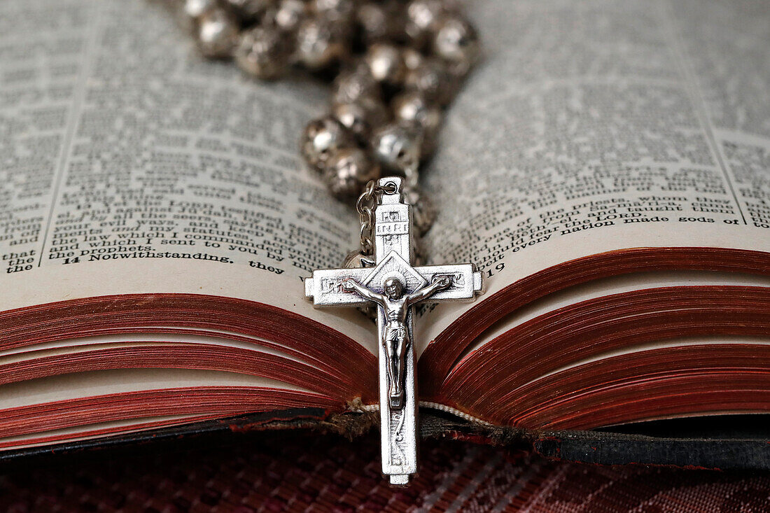 Vintage rosary with crucifix on an open Bible, Christian religious symbol, France, Europe