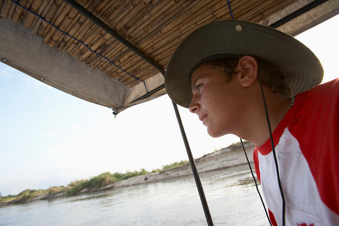 Young Male Tourist On Covered Boat On The Rufiji River