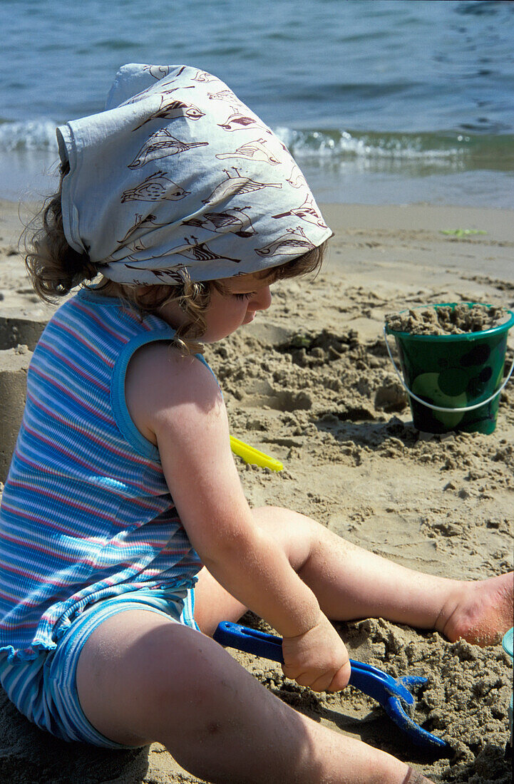 Young Girl Playing On Sandy Beach