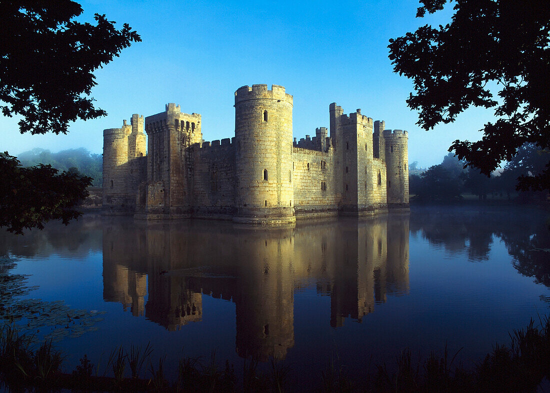 The Majestic Bodiam Castle And Its Reflection In Surrounding Moat.