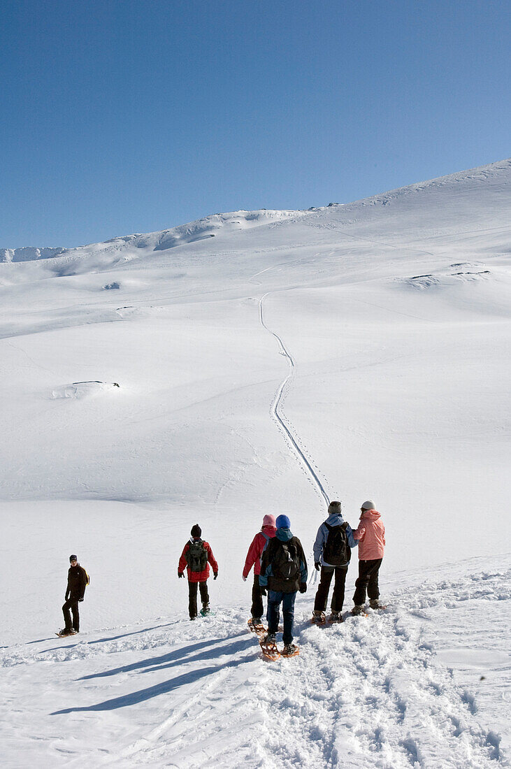 Snowshoeing At Grimsel Pass Which Offers Fantastic Views Over The Goms Valley.
