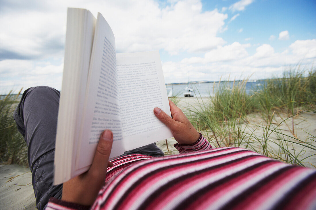 Woman Reading On Beach