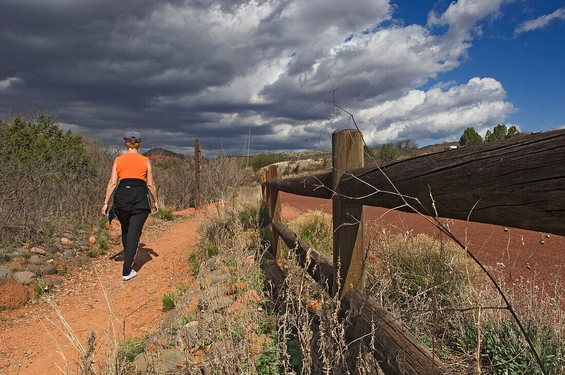 A Woman On A Nature Walk Through Red Rock State Park.