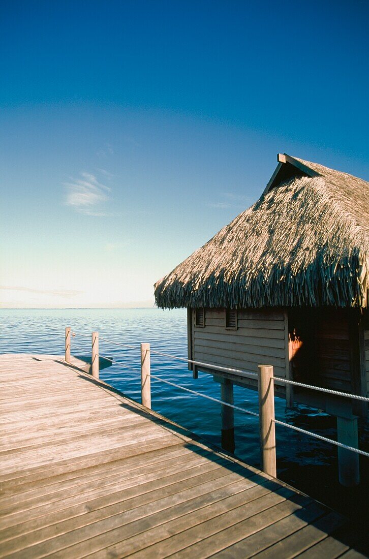 Wooden Hut On Stilts With Jetty In Sea