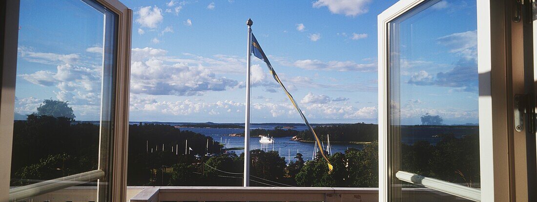 View Through Double Windows To A Swedish Flag And Across Uto Island.