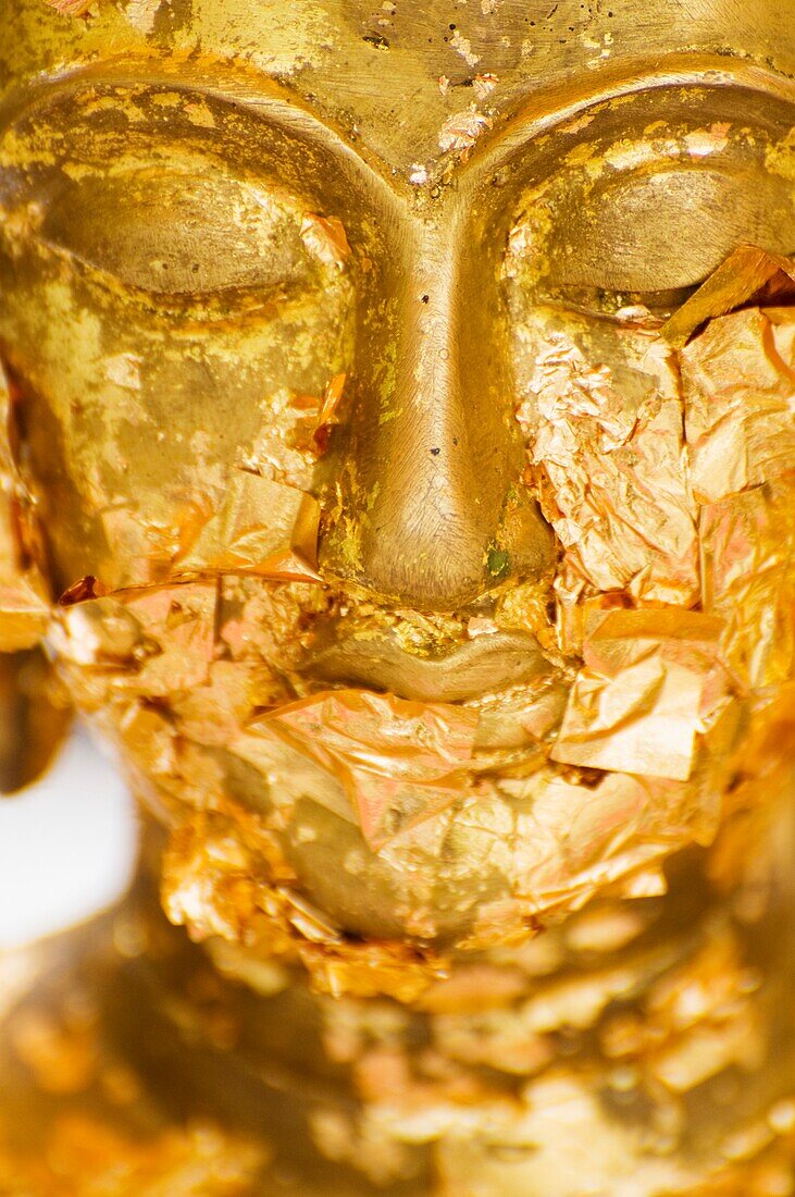 Gold Leaf Offerings On Statue At Wat Phra Kaew Temple