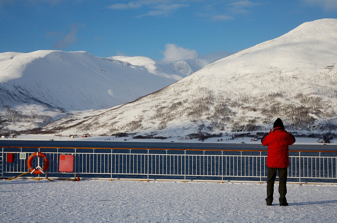 Man Looking At Landscape From Ship