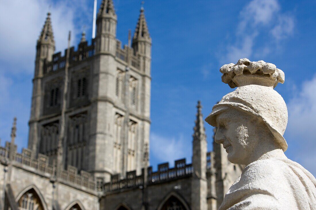 Statue Overlooking Roman Baths With Bath Abbey In Background