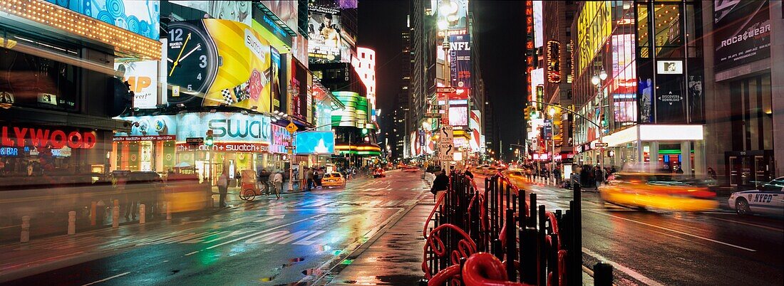 Neon Advertising Hoardings, Tourists And Traffic At Times Square