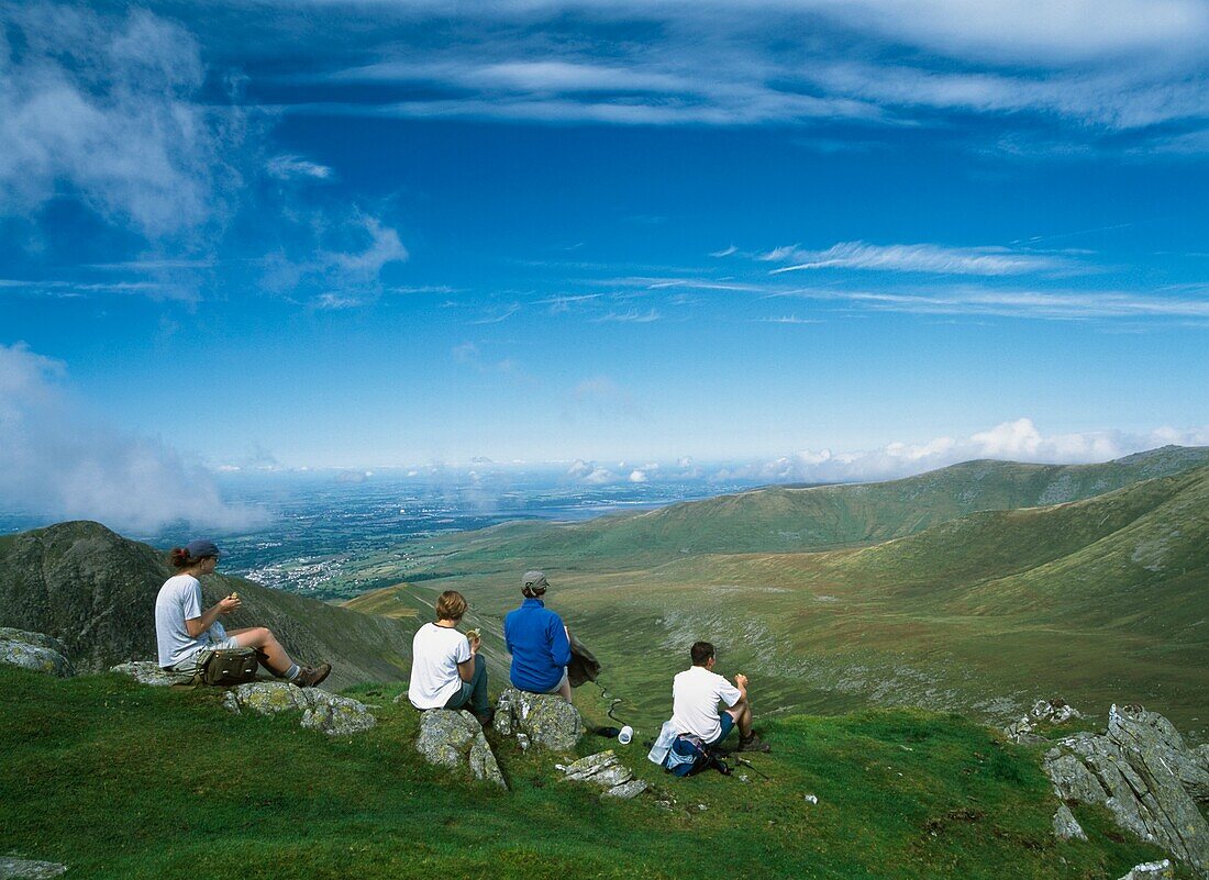 Four Tourists Looking At Bangor From Mountain Top