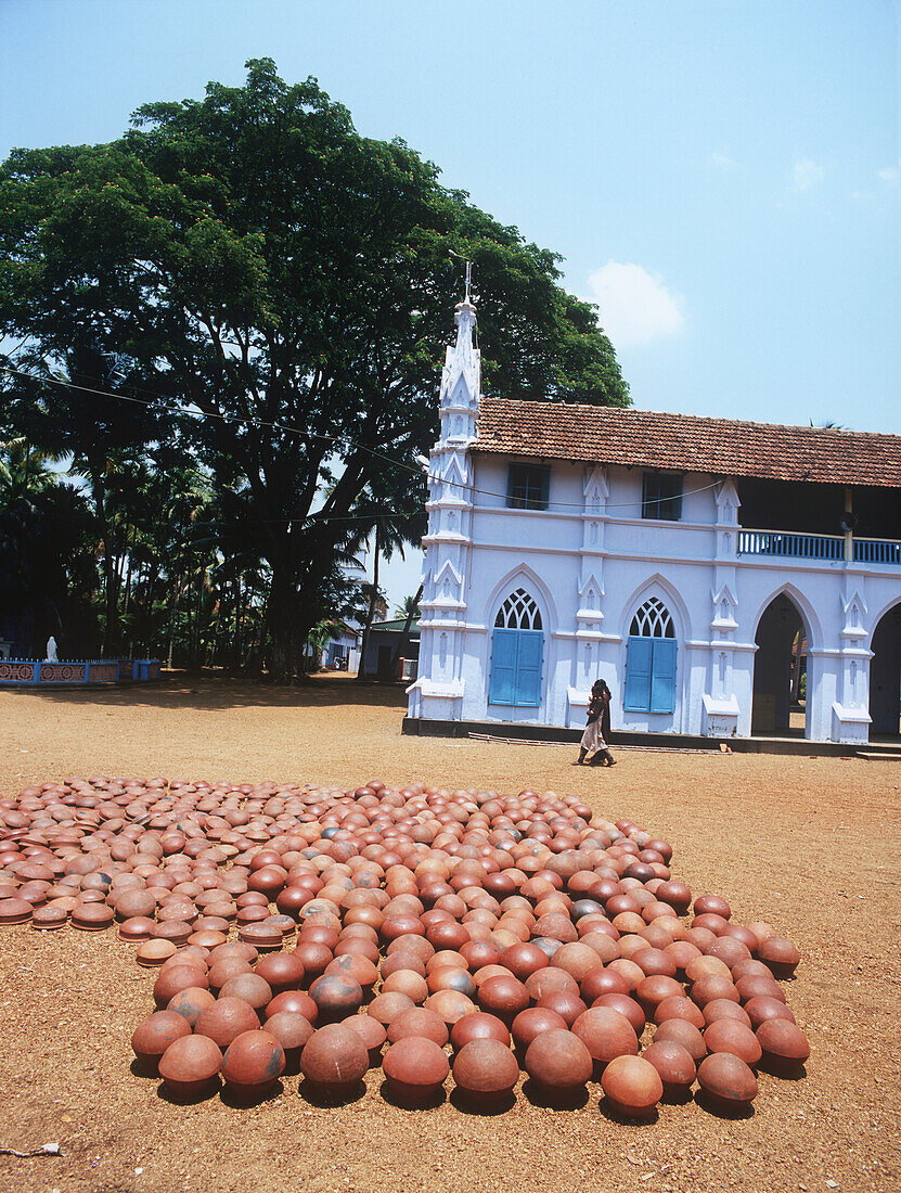 Two Local Women Walking Along House