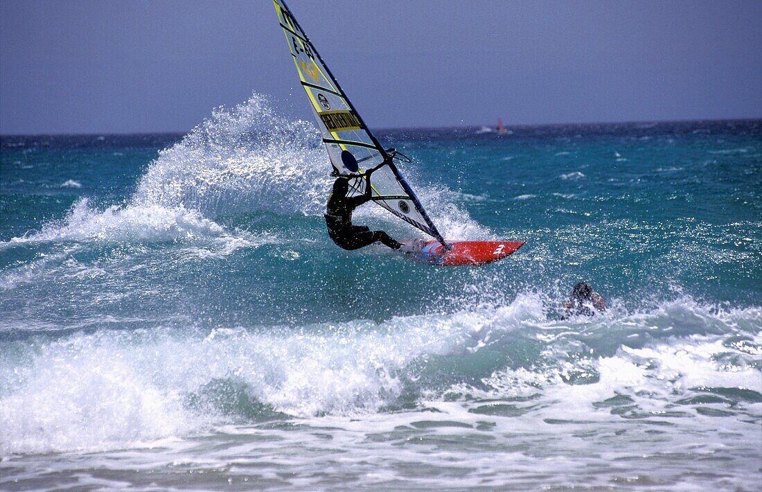 Three Windsurfers On Ocean