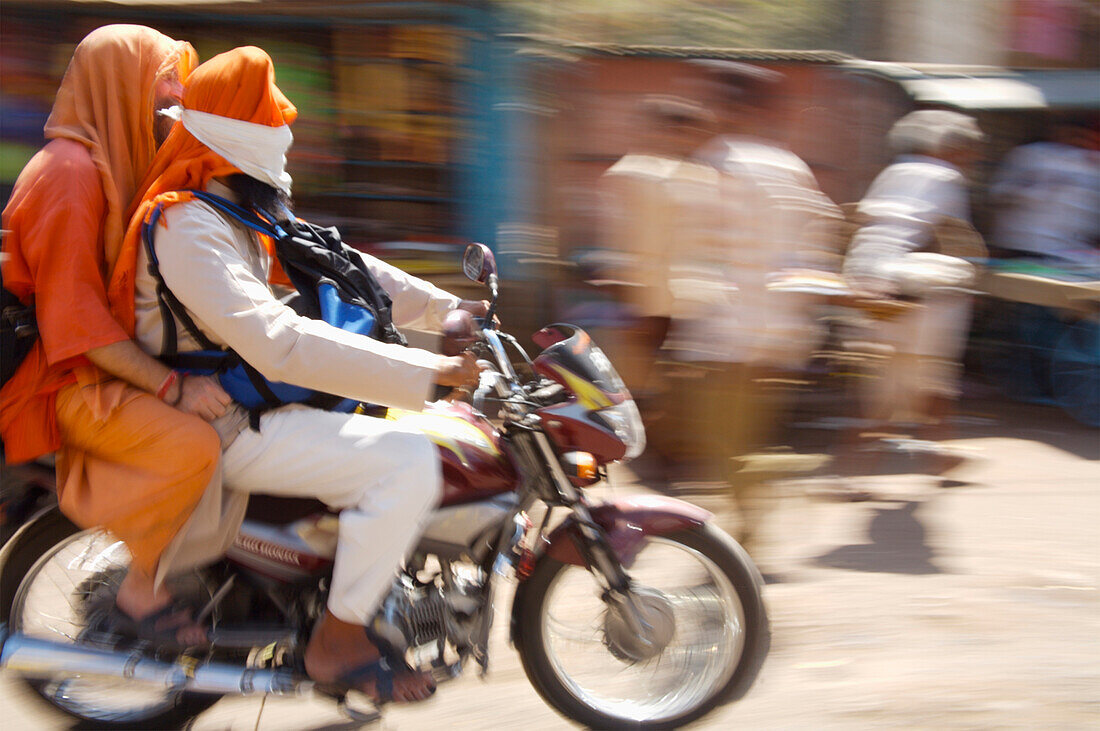 People Riding Motorcycle In Street