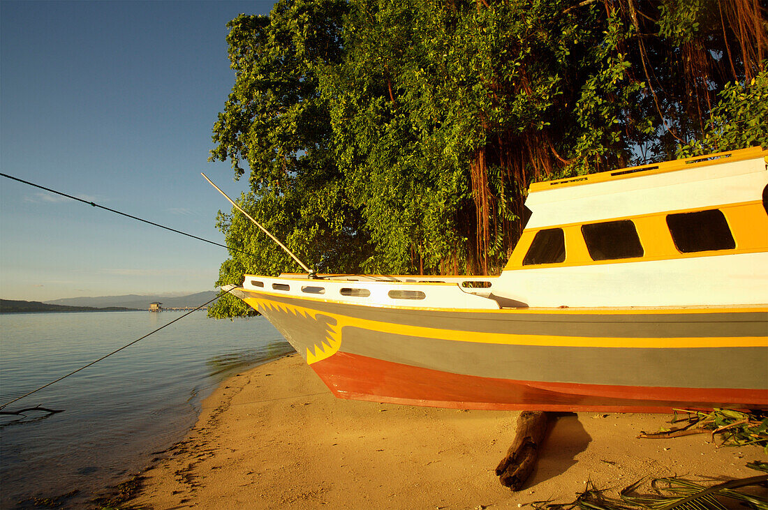 Indonesia, Sulawesi, Boat on Sandy Beach; Bunaken