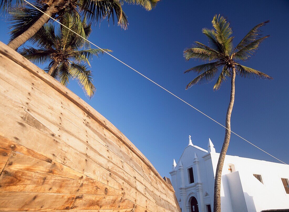 Palms Trees And Hull Of Fishing Boat Beside The Church Of Santo Antonio,Ilha De Mocambique,Mozambique.