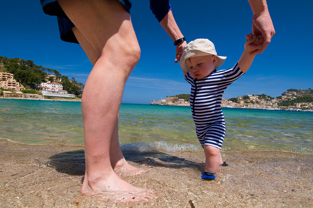 Father Helping Baby Boy (6-11 Months) Walk On Beach, Soller,Majorca,Balearic Islands,Spain
