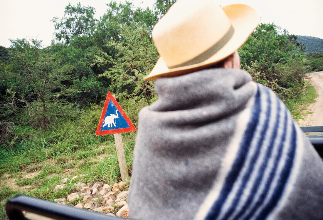 Man In Safari Car / Jeep Watching In Shamwari Game Reserve & Elephant Road Sign,Eastern Cape,South Africa.