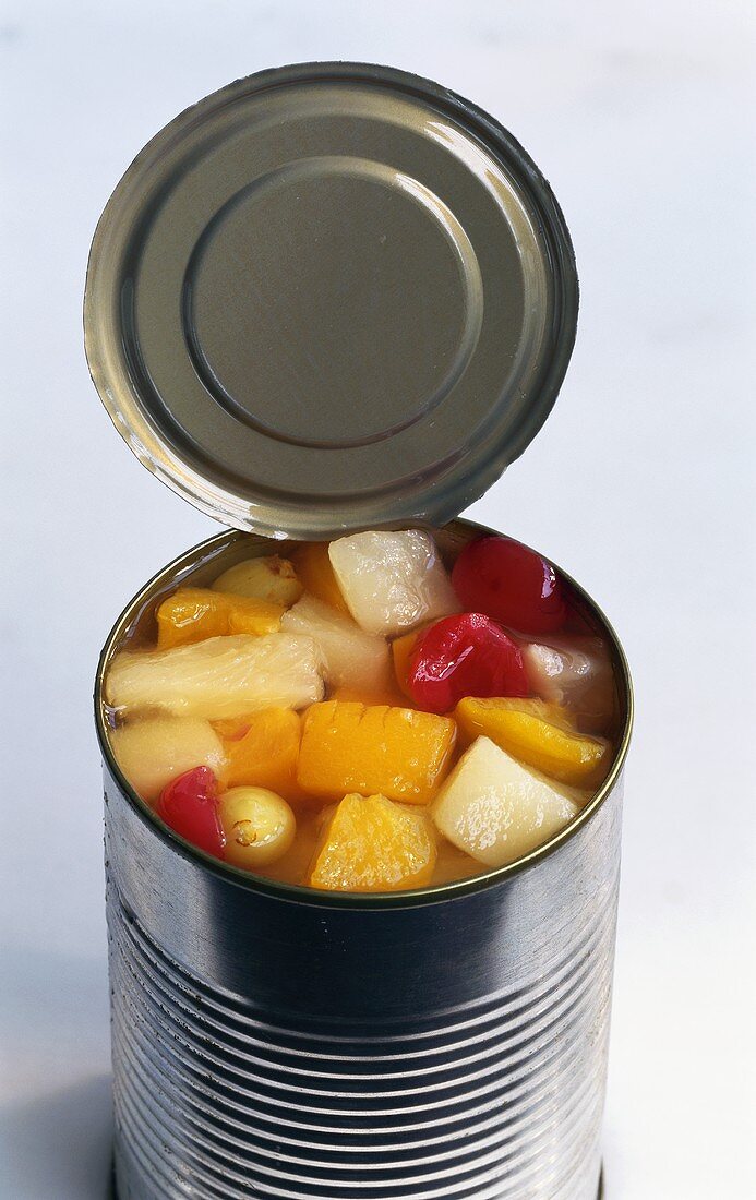 An opened tin of mixed fruit