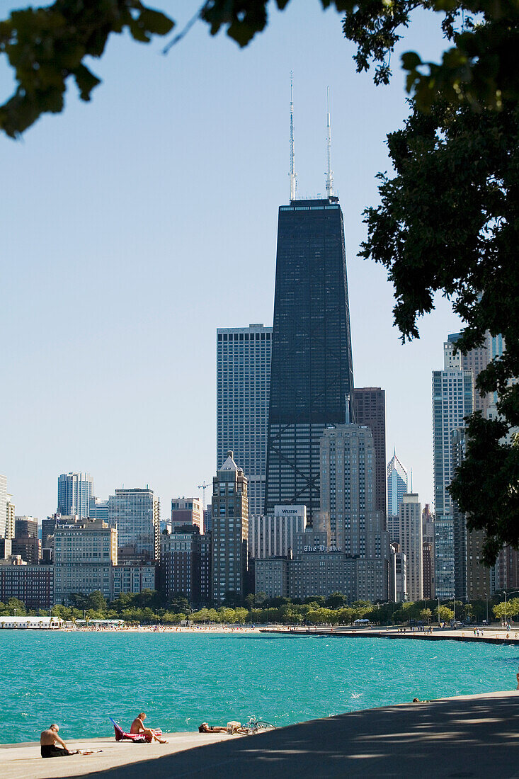 People Basking On Oak Street Beach With High Rise Buildings In Background, Chicago,Illinois,Usa