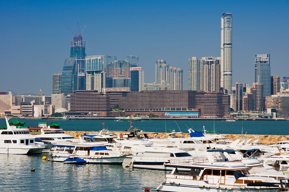 Boats At Causeway With City Skyline