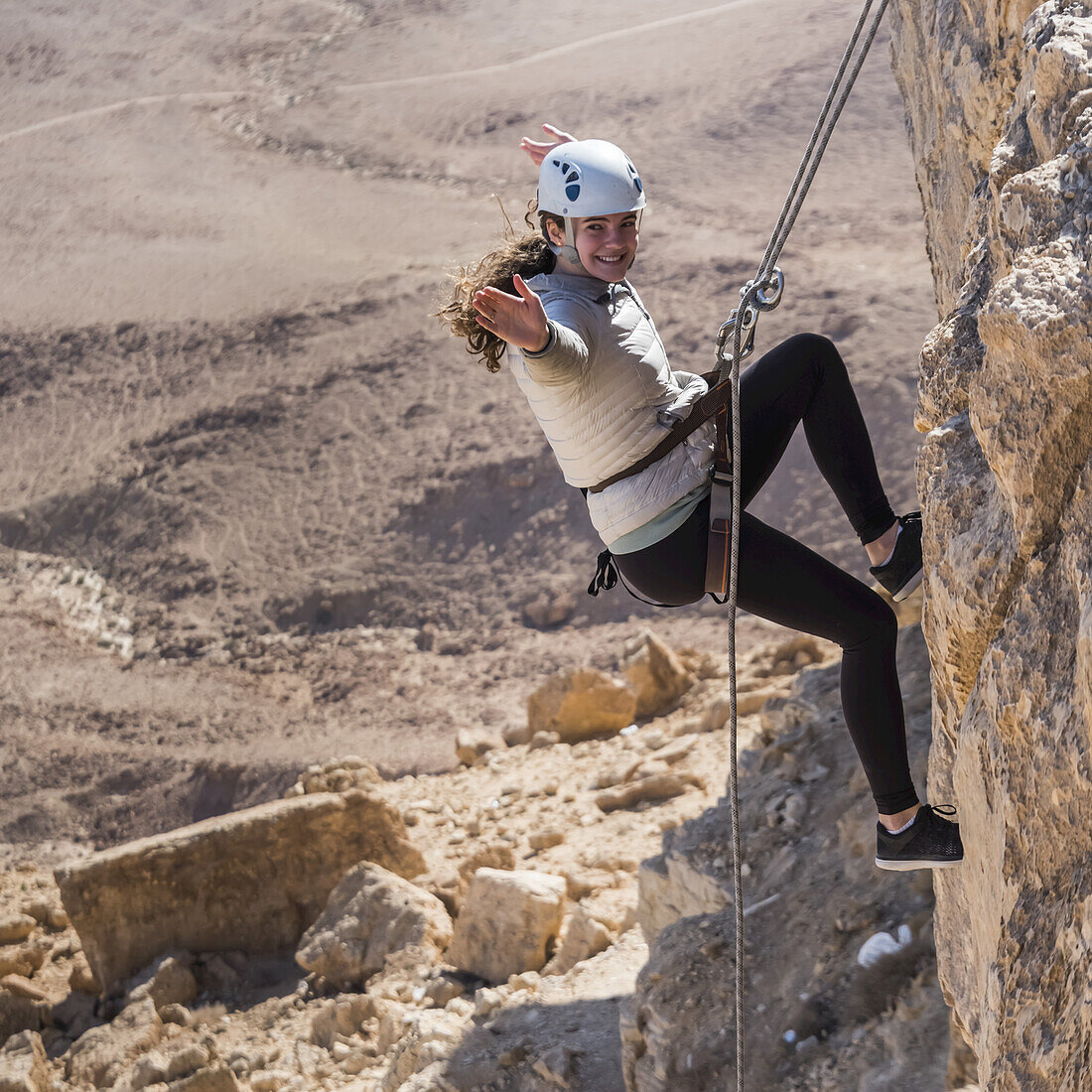 A Young Woman Rappelling Into Ramon Crater, Ramon Nature Reserve; Mitzpe Ramon, South District, Israel
