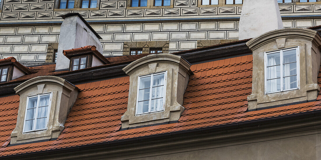 Facade Of A Building With Three Windows, Tile And Chimneys; Prague, Czechia