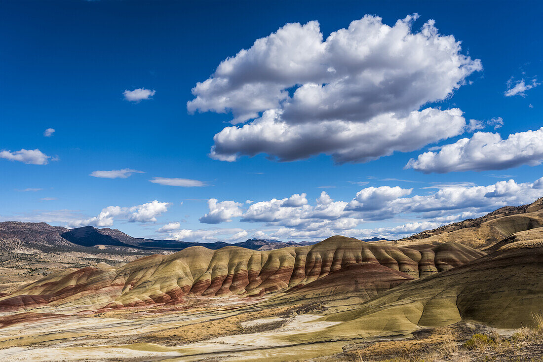 Clouds float above the Painted Hills Unit of John Day Fossil Beds National Monument; Mitchell, Oregon, United States of America