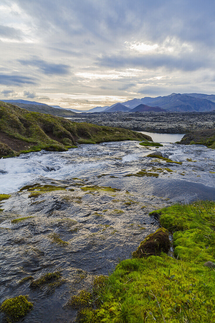 A gorgeous fresh water river runs through a valley in Western Iceland; Iceland