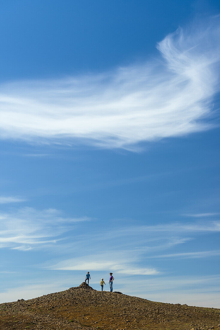 Mother and kids on top of hill near Geysir; Iceland