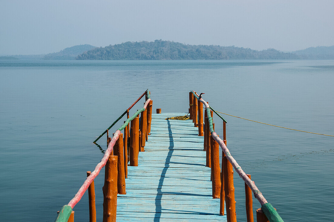 A dock leading out to the tranquil waters in the Bay of Bengal; Andaman Islands, India